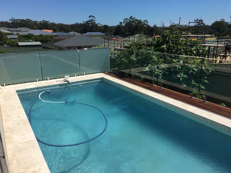 Pool fencing with top rail.