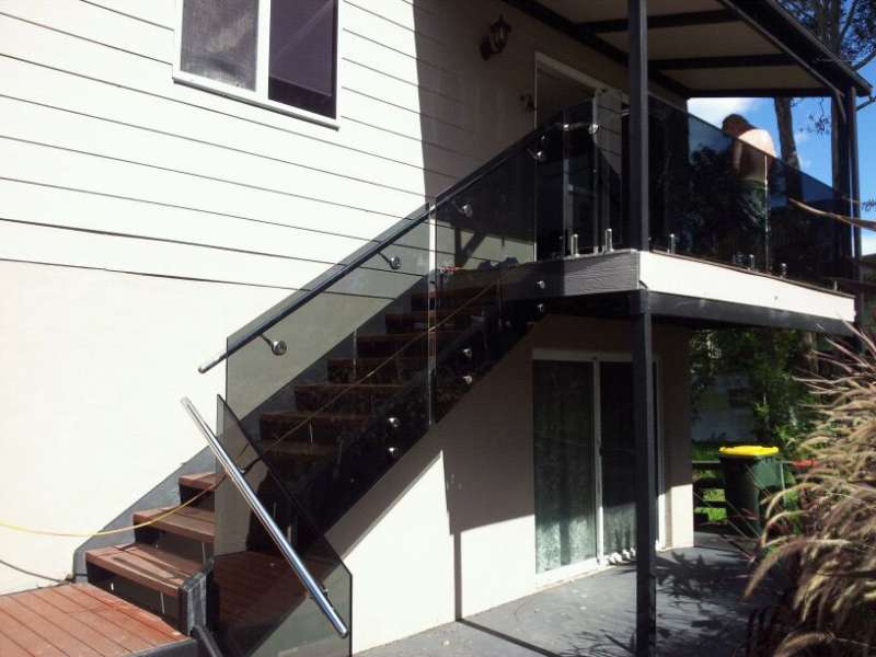 Frameless Glass tinted with Stainless Steel handrail.